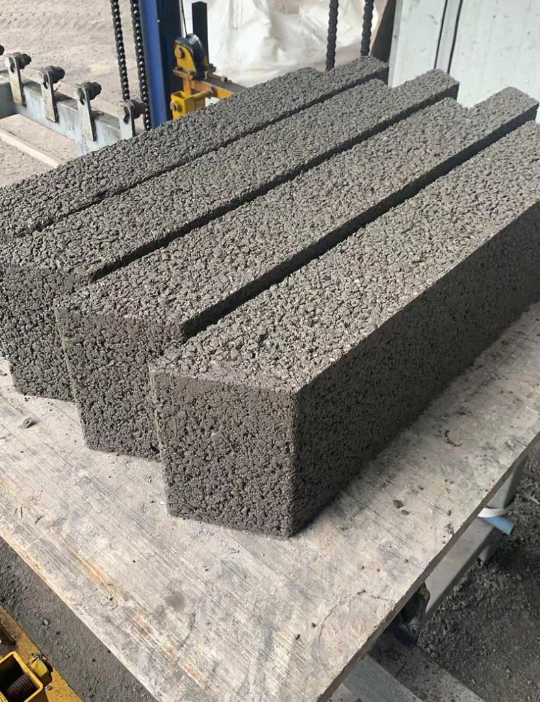 近景特写呈并排摆放的深灰色多孔硅砂砌块,可以清晰看到表面的微孔结构